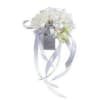 White floral wrist corsage with silver ribbon streamers