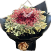 Bouquet of red roses with pink baby's breath and folded dollar bills
