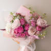 Pink and white mixed bouquet wrapped in translucent paper with a ribbon