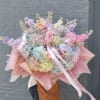 An oversized, hand-held pastel bouquet that reads like a daydream-perfect as a