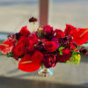 This striking red-themed flower centerpiece is the perfect addition to elevate any