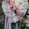 Heart-shaped floral arrangement with pink roses and white carnations