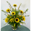 Sunflower arrangement in a silver vase with wheat accents