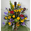 Colorful mixed bouquet in a bronze vase with yellow, purple, red, and dark blooms