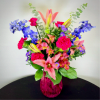 A bold and romantic bouquet featuring pink lilies, lush carnations, and pops