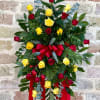 A tall standing spray of red and yellow roses makes a bold