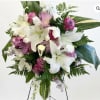 Romantic standing spray featuring white lilies, lavender roses &amp; white chrysanthemums. A