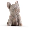 Small gray dog figurine sitting on a white background
