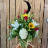 Bouquet of red roses, white lilies, and yellow sunflowers in a glass vase