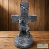 Decorative wooden cross with deer figures on a tabletop
