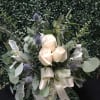 Eucalyptus and various greenery adorned with delightful white roses, arranged in a
