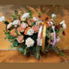 Peach and white mixed flower arrangement with ribbon in a vase