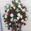 Standing wreath of red and white roses with patriotic ribbon
