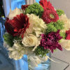Bouquet of red and white flowers in a clear glass vase