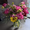 Pink and yellow mixed bouquet in a clear glass vase