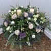 Floral wreath with roses, thistles, and candles
