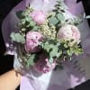 Pink peonies with eucalyptus in lavender wrapping paper