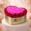 A sculpted heart of preserved roses-blushing pinks clustered at the center and