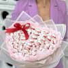 A rounded, candy-filled bouquet of individually wrapped Raffaello and Ferrero Rocher confections
