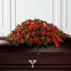 A graceful and deeply meaningful tribute, this casket spray of red roses