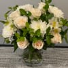 Bouquet of white roses and white chrysanthemums in a clear glass vase