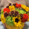 Mixed flowers arranged in a pumpkin-shaped container