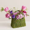  This arrangement made with purple and lavender roses and other blooms