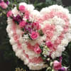 This arrangement make with pink and white carnations and lavender roses 