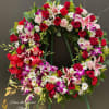 This Beautiful wreath made with dendrobium  orchid, red roses and pink