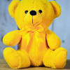 Yellow teddy bear with a satin bow