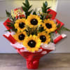Sunflower bouquet in red wrapping with birthday toppers