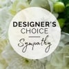 White floral arrangement with a sympathy label