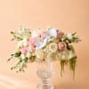 Pink and white floral arrangement in a clear glass vase