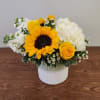 Yellow sunflower and rose arrangement in a white vase with white blooms