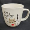 White mug with a cat illustration and the words "Home is where my cat is"