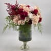 Bouquet of red, blush, and cream roses in a glass vase