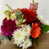 In s hlass vase combination of different colors of chrysanthemums