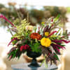 Colorful floral arrangement in a black pedestal vase