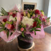 cut flowers wrapped in paper such as roses, hydrangeas and other fresh