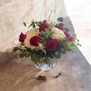 Deep red roses paired with billowy white hydrangeas form a striking rose