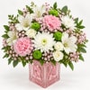 Pink and white mixed bouquet in a pink glass cube vase
