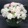 Peonies with greens in a vase