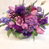 Purple and pink mixed bouquet in a glass vase