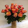 Bouquet of orange-pink roses in a burlap-wrapped vase