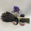 Bundle of dried lavender with three black-lidded jars and a purple sachet