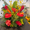 Tropical arrangement with red anthuriums, ginger, and yellow orchids
