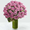 Bouquet of pink roses in a tall green glass vase