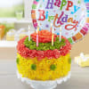 Flower cake with candles and a birthday balloon