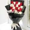 Bouquet of red and white roses wrapped in black paper with a white ribbon