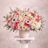 Large bouquet of pink and white roses in a white vase